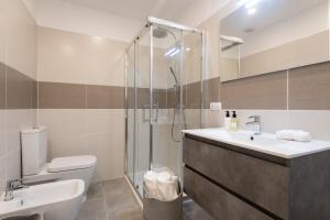 a bathroom with a shower and a sink and a toilet at Sony Cosi Loft Canteras in Las Palmas de Gran Canaria +12 photos