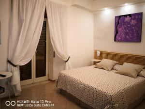 A bed or beds in a room at Casa Nel Cuore Di Napoli centro storico