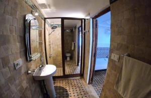 a bathroom with a sink and a shower and a toilet at Hostel Amir in Fez