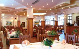 jadalnia ze stołami i krzesłami w restauracji w obiekcie Hotel Zlatiborska Noc w mieście Užice