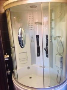 a shower with a glass door in a bathroom at Robinzon in Kaliningrad