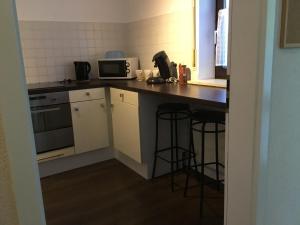 a small kitchen with a counter and a microwave at Ferienwohnung Leitner in Laufenburg