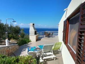 a patio with chairs and a table and the ocean at Holiday home Ivo in Prigradica
