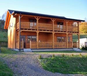 a large wooden house with a large deck at Noclegi u Bartka i Magdy in Solina