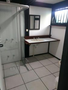 a bathroom with a sink and a shower at Pousada Morada Das Toninhas in Ubatuba