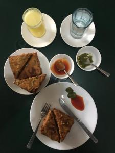 a table topped with plates of food and drinks at OmBodhi Retreat in Kumta