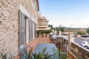 a balcony with tables and chairs on a building at Son Gris in El Port de la Selva