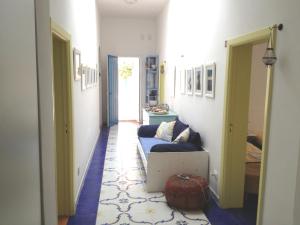 a hallway with a couch and a room with a door at Villa Lucky in Punta Prosciutto