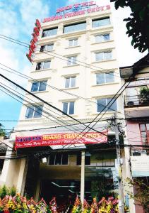 a tall white building with a sign on it at Hoang Thanh Thuy Hotel 2 in Ho Chi Minh City