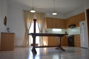 a kitchen with a table in the middle of it at United blue Resorts - White Sand in Karteros +33 photos