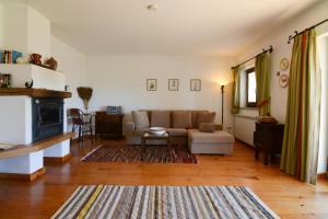 a living room with a couch and a fireplace at Casa da Menina in Anceriz