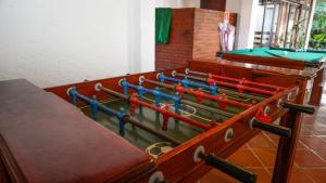 a row of ping pong tables in a room at Pousada das Garças in Saquarema