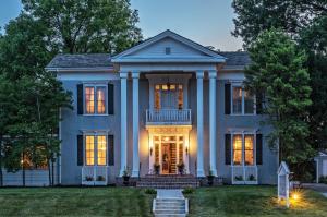 a blue house with columns at Silver Heart Inn & Cottages in Independence