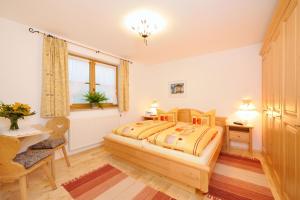 a bedroom with a bed and a desk and a chair at Ferienwohnung Haus Josefa in Burgberg