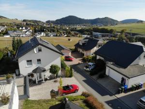 an aerial view of a house with a red car in a driveway at Ferienwohnung Sommerwind in Willingen