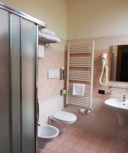 a bathroom with a toilet and a sink at Hotel Cris in Mestre