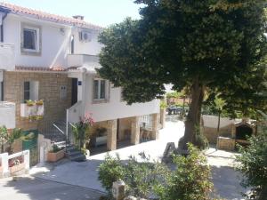 a house with a tree in front of it at KATY&MLADEN in Baška