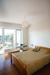 a bedroom with a large bed and a large window at New apartament very close to the city centre in Vilnius