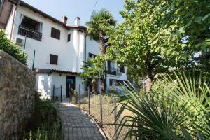 a white house with a fence in front of it at Apartment Tasha's Home in Opatija