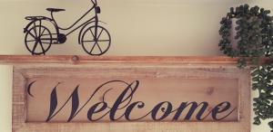 a sign that says welcome with a bike on it at Airanloch, Loch Ness, Adult Only in Lochend