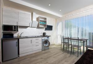 a kitchen with a sink and a washing machine at Apartamenty Terrasa in Chornomorsk