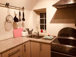 a kitchen with a sink and a stove at Centralt i Gentofte i 2 plan, ved S-Tog og busser in Gentofte
