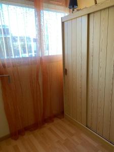 an empty room with a door and a window at Le Capitole in Narbonne-Plage