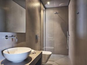 a bathroom with a sink and a toilet and a shower at Vais Luxury Villas in Agios Nikolaos
