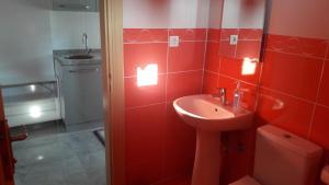 a red bathroom with a sink and a toilet at Gunay Pansiyon Antalya in Antalya +30 photos
