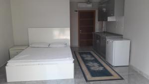 a small room with a bed and a refrigerator at Gunay Pansiyon Antalya in Antalya