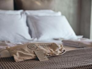 a brown bag sitting on top of a bed at Vais Luxury Villas in Agios Nikolaos