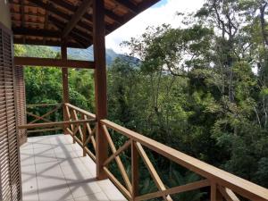 a balcony with a view of the forest at Casa e Chalé na Praia do Julião in Ilhabela