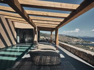 a bedroom with a view of the ocean at Vais Luxury Villas in Agios Nikolaos