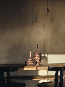 two vases sitting on top of a table at Vais Luxury Villas in Agios Nikolaos