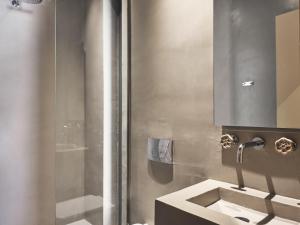 a bathroom with a sink and a shower at Vais Luxury Villas in Agios Nikolaos