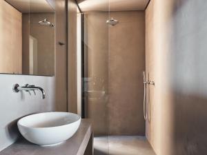 a bathroom with a sink and a glass shower at Vais Luxury Villas in Agios Nikolaos