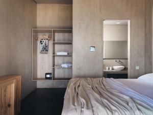 a bedroom with a bed and a sink at Vais Luxury Villas in Agios Nikolaos