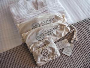 two bags of cookies sitting on a bed at Vais Luxury Villas in Agios Nikolaos
