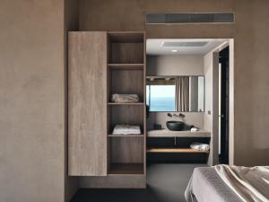 a bathroom with a sink and a mirror at Vais Luxury Villas in Agios Nikolaos