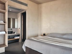 a bedroom with a bed and a sink at Vais Luxury Villas in Agios Nikolaos