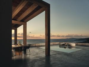 a patio with a table and a view of the ocean at Vais Luxury Villas in Agios Nikolaos