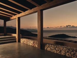 a view from the porch of a house overlooking the ocean at Vais Luxury Villas in Agios Nikolaos