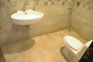 a bathroom with a sink and a toilet at House of Traditions - Family Suite in Islamabad