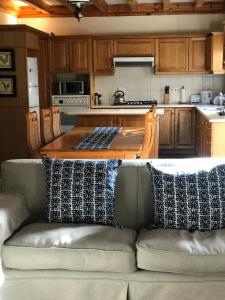 a couch with pillows on it in a kitchen at Chinta Cottage Hermanus in Hermanus