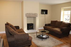 a living room with two couches and a fireplace at Hollywood House in Hollywood
