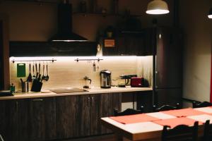 a kitchen with a counter and a table with utensils at Good Night rooms & hostel in Murmansk