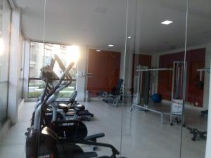 una palestra con diversi tapis roulant e uno specchio di Flat no Aldeia das Águas (Deluxe) a Barra do Piraí