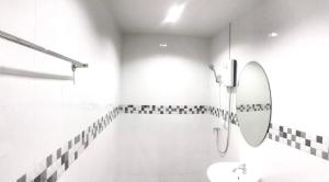a white bathroom with a sink and a mirror at Rest Point Sampran in Nakhon Pathom +9 photos