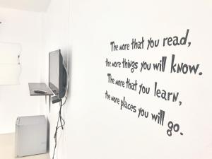 a wall sticker in a room with a tv at Rest Point Sampran in Nakhon Pathom