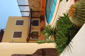 a close up of a building with a plant next to it at El Mosaico Del Sol in Lampedusa